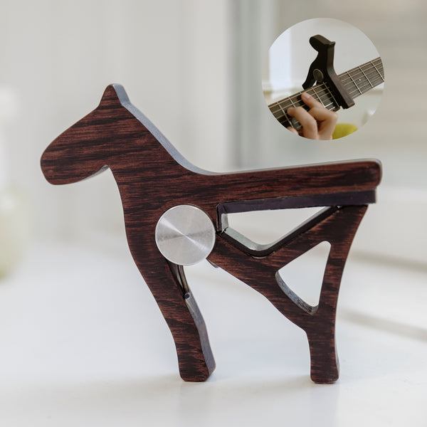 Carved from the leftover mahogany of Harmoni’s neck. The horse, a Nordic symbol of journey, travels with you as a capo.
