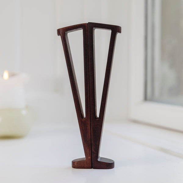 Precision-cut from the neck’s remaining wood. Our sculptural stand is the world’s smallest—and most beautiful—guitar stand.